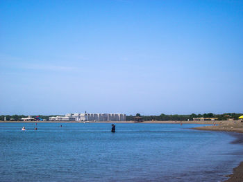 Scenic view of sea against clear blue sky