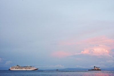 Ship sailing in sea against sky