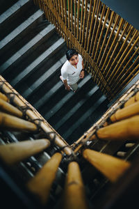 High angle view of man standing on staircase