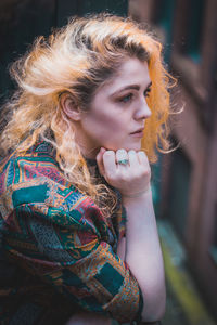 Close-up of thoughtful young woman with dyed hair