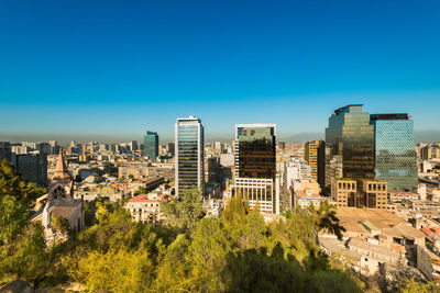 Cityscape against clear blue sky