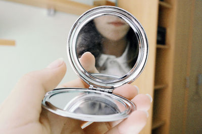 Close-up of hand holding mirror