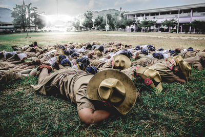 Group of people relaxing on field