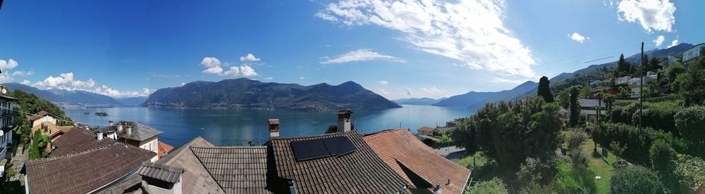 Panoramic view of buildings and mountains against sky