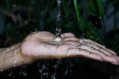 Close-up photo of water splash on hand