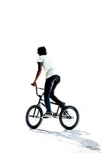 Man riding bicycle on white background
