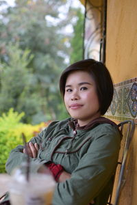 Portrait of girl sitting outdoors