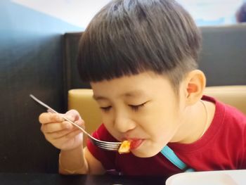 Portrait of boy drinking coffee