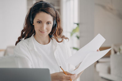 Portrait of young woman using digital tablet