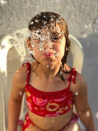 Close-up of girl spraying water from mouth