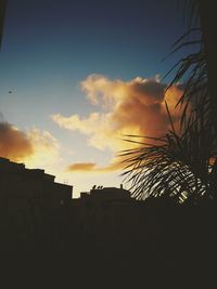 Low angle view of silhouette buildings against sky during sunset