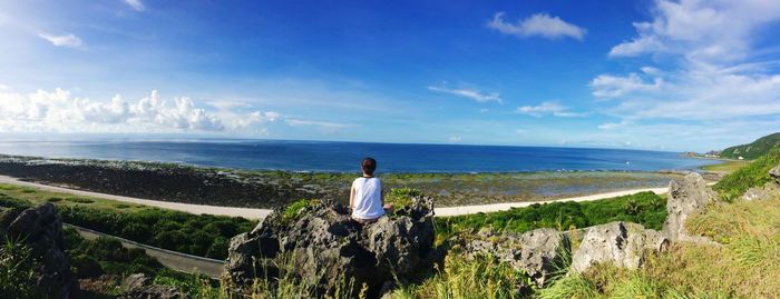 Rear view of woman looking at sea against sky