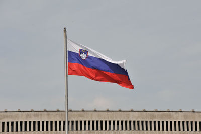 Low angle view of slovenian flag waving against sky