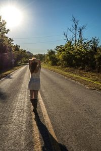 Rear view of people walking on road