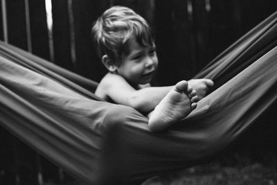 Rear view of boy looking at camera