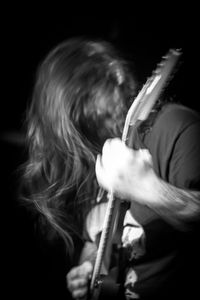 Man playing guitar at music concert