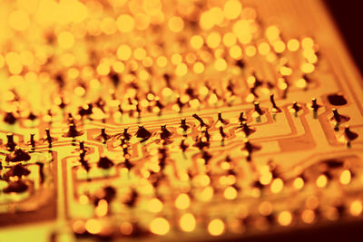 Close-up of illuminated lamp on table