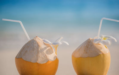 Two orange coconut on a beach