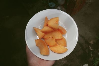 High angle view of hand holding ice cream in bowl