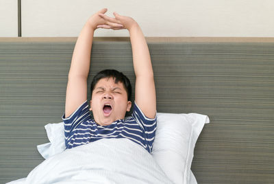 Portrait of boy relaxing on bed