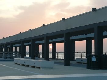 Bridge over sea against sky during sunset