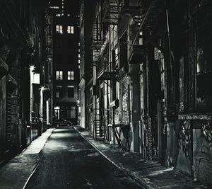Narrow walkway along buildings at night