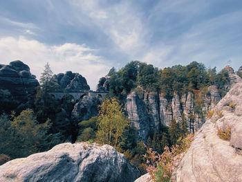 Panoramic view of rocks and trees against sky