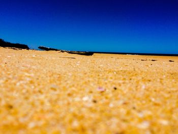 Scenic view of desert against clear blue sky