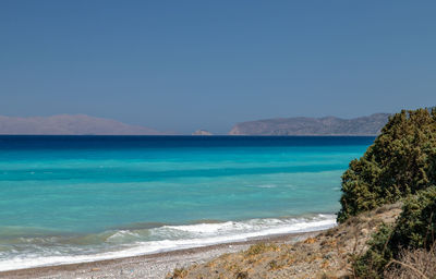 Scenic view of sea against clear blue sky