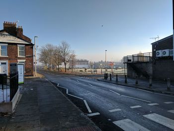 Road in city against clear sky