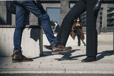 Two people greeting with feet during pandemic