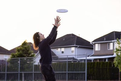 Man playing with ball against sky