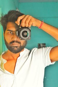 Portrait of young man photographing