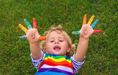 High angle view of cute girl with toys on grass