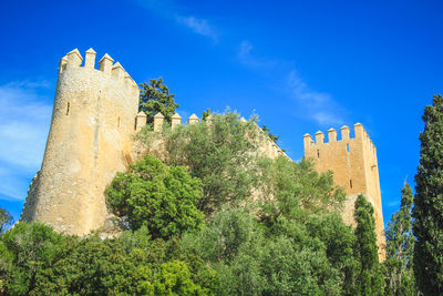 Low angle view of historic building against blue sky