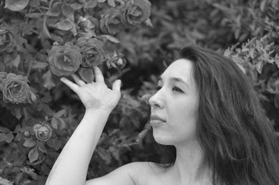 Close-up of woman with flowers in hand