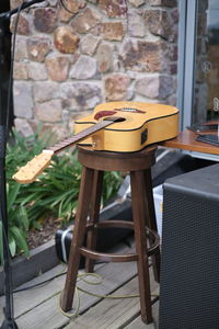 Empty chair and table against wall