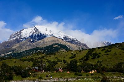 Scenic view of mountains against blue sky