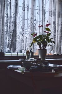 Close-up of flower vase on table at home