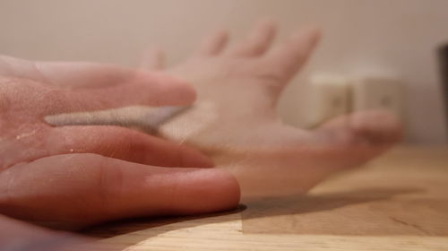 Close-up of hands on table