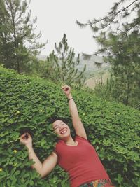 Portrait of friends standing by tree