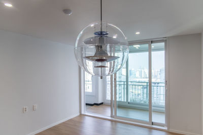 Illuminated pendant lights hanging on ceiling of building