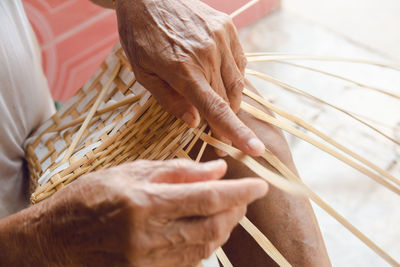 Close-up of man holding wicker basket