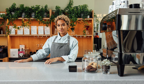 Portrait of young woman sitting in office