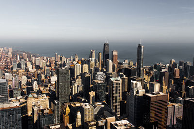 Aerial view of buildings in city against sky