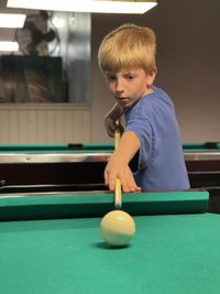 Boy playing pool