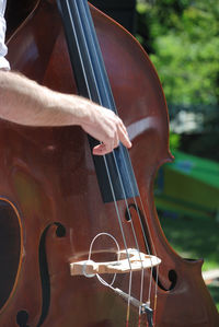 Cropped hand of man playing cello