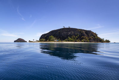 Scenic view of sea against blue sky