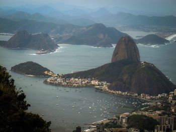 High angle view of sea and mountains against sky