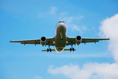 Low angle view of airplane flying against sky